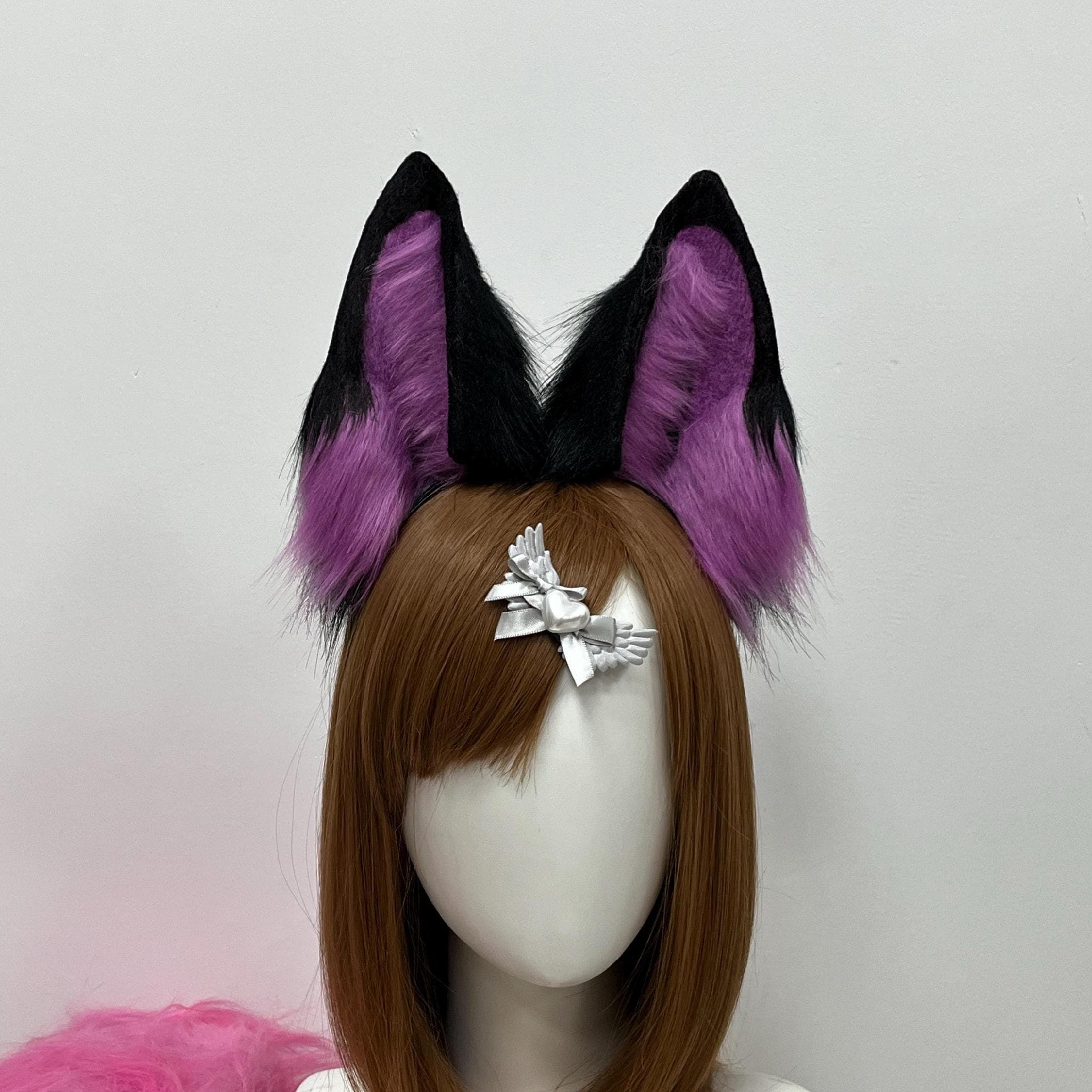 Handmade purple and black faux fur wolf ears headband shown front view, featuring tall pointed realistic ear shape with rich orchid violet inner fluff and jet black outer rims. Perfect kemonomimi accessory for anime cosplay looks, Halloween costume parties, furry fursona builds, dark fae roleplay, and LARP midnight witch characters. Lightweight comfy headband stays put all day and makes an instant statement at any con with that mystical alert wolf silhouette.