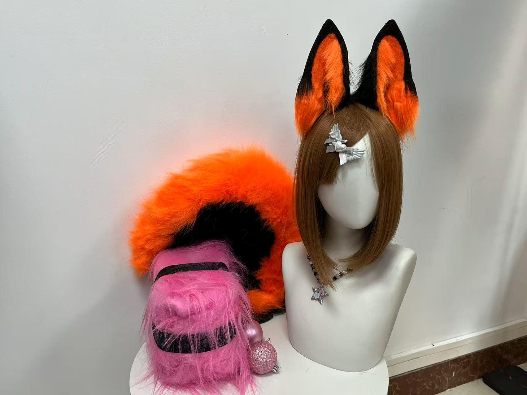 Bright orange and black faux fur fox ears headband plus fluffy fox tail set front view, upright pointed ears with vivid orange inner fur and jet black tips displayed alongside long bushy kitsune style tail. Perfect for Halloween cosplay costume anime convention kemonomimi character build furry fandom streetwear rave festival outfit photoshoot birthday gift. Lightweight comfortable slim headband base stays secure for all-day con wear. Handmade plush fox animal ear accessory for cosplayer.