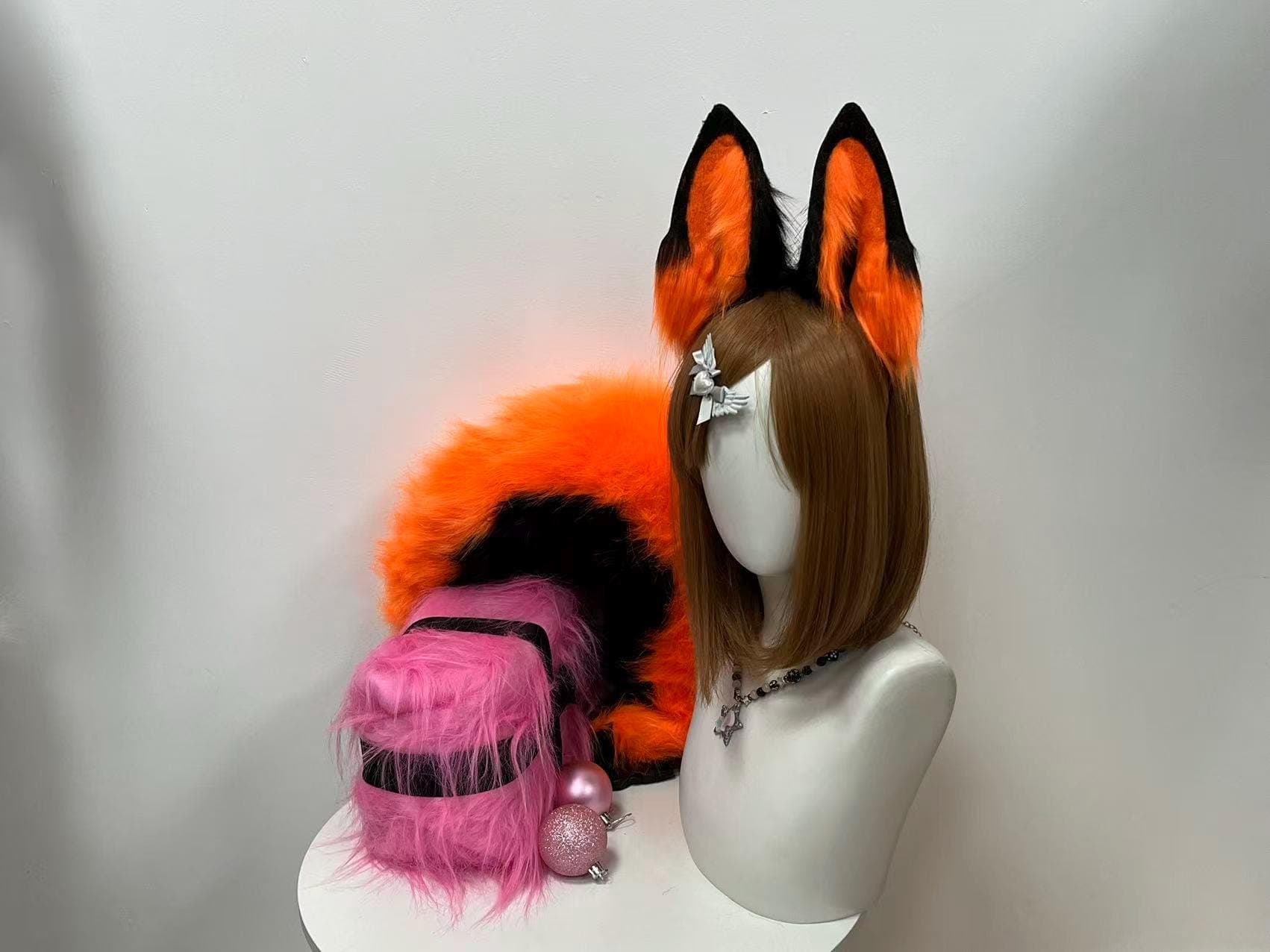 Angled front view of black and bright orange faux fur fox ears headband with long bushy tail set, handmade plush cosplay costume accessory perfect for kitsune cosplay furry neko persona builds. Premium soft faux fur vibrant orange inner with contrasting black tip detail realistic fox proportions for anime convention kemonomimi character outfit rave festival wear. Lightweight secure headband base handcrafted fox ears and tail combo ideal for Halloween costume party photoshoot gift.