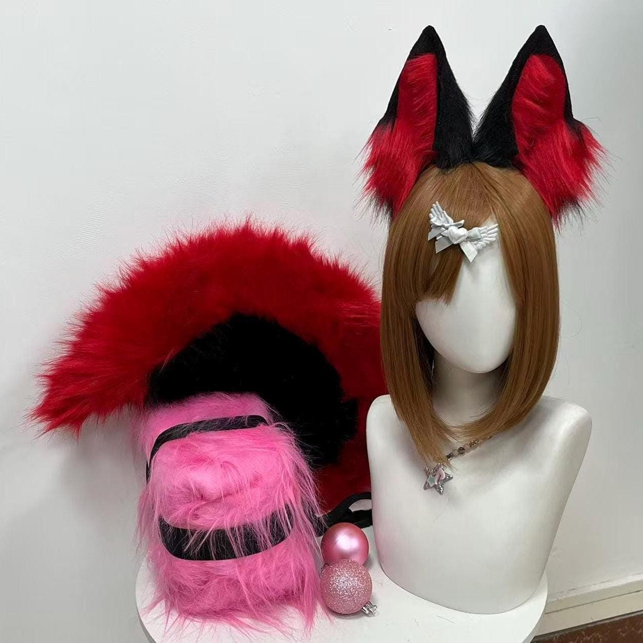 Front hero display shot of black and blood red fox ears and tail set showing the huge full fluffy plume curving upward like a vibrant flame silhouette beside upright pointed dual tone ears. The tail features red topside with deep black underside creating a striking arc. Perfect showcase angle demonstrating the bold scale of the fluffy plume, the pointed fox ear shape, and the cohesive dark warrior red color palette of this handmade kit for serious cosplayers.