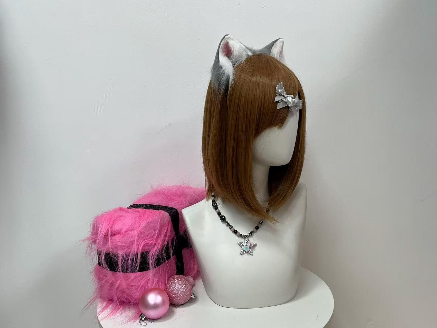 Three-quarter angle of the grey lynx-inspired kitten ears tilted gently toward the viewer, capturing the dimensional curve of each sculpted shell, wispy ivory fringe fluttering along the inner rim, and blush pink pockets peeking out between feathered tufts. A go-to statement piece for cosplayers building gothic lolita looks, therian photoshoots, convention hallway candids, indie film shoots, or Halloween costume parties craving wild-cat realism all night.