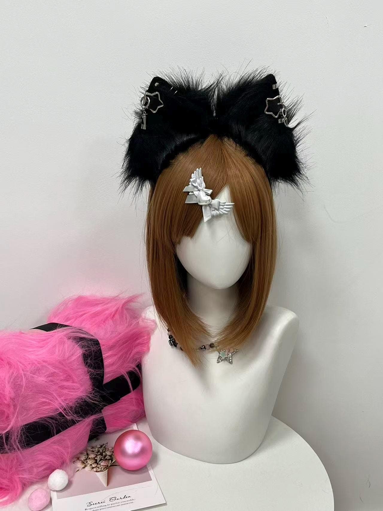 Alternate straight on front capture of the black fluffy fox ear headband showing fuller ear volume and the deep raven black faux fur catching light from above. Highlights how symmetric the silver star piercing hardware sits, with matching chain charm dangles framing each pointed ear base. Great pick for cosplayers building a midnight demon, kitsune yokai, werewolf hybrid, dark academia bookworm, or emo streamer character. Soft brushable pile feels silky and holds shape through con days.