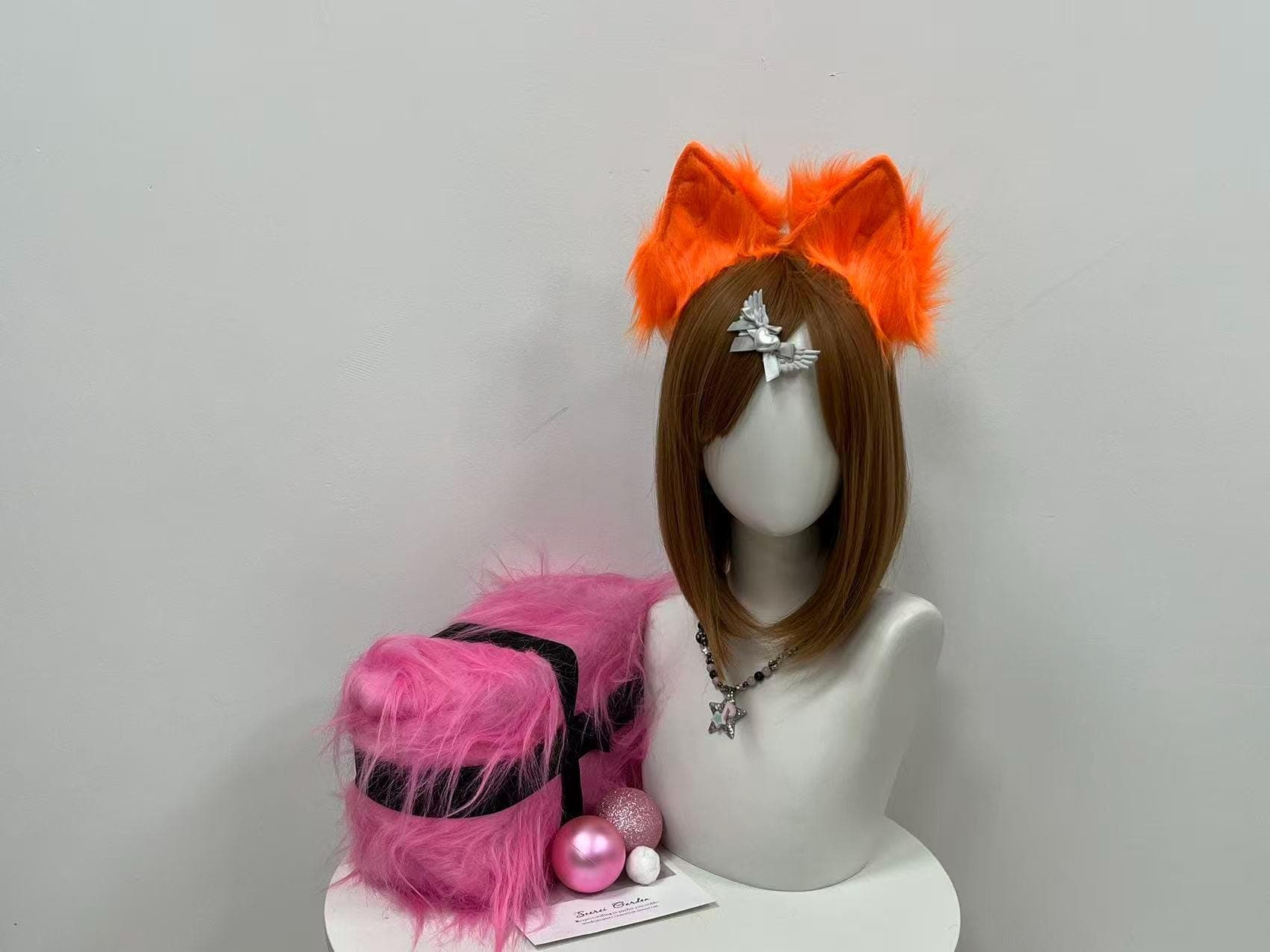 Bold neon orange fox ears perched on a flexible headband, ready to top off any kitsune build for your next con weekend. Vibrant tangerine faux fur catches the spotlight while velvety matte inner panels add structured contrast and a clean shape. Handmade pointed peaks give a sharp, alert silhouette ideal for fursonas, anime fox spirits, gijinka builds, Halloween parties, or convention photo ops. Soft fluff stays comfy through panel hops and late-night meetups.