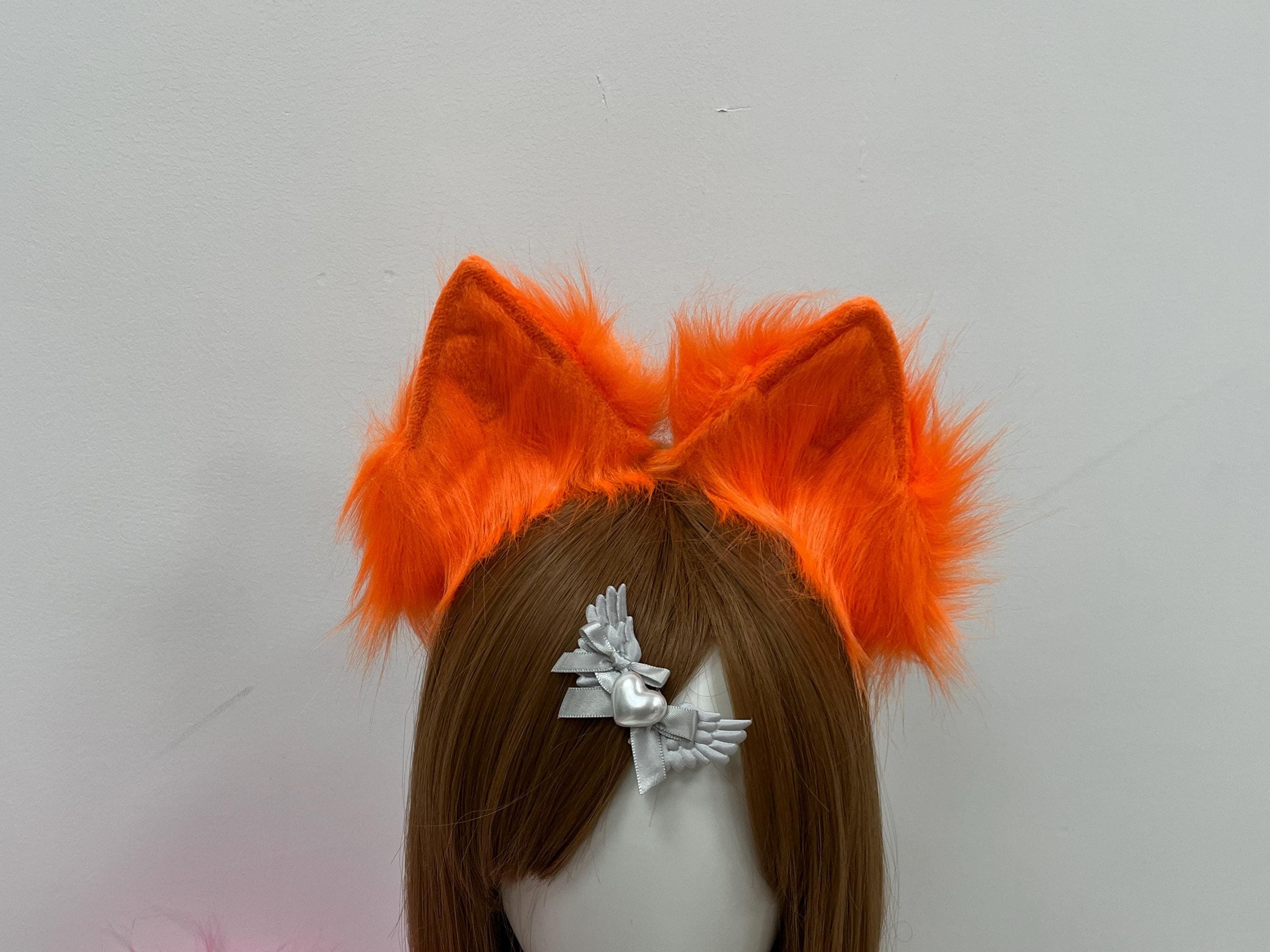 Front-facing close-up of the structured peak on these handmade fox ears: bright orange faux fur flowing outward from contrasting matte velvet inner panels in a deeper rust shade. The shaped form creates a crisp foxy silhouette beloved by furry fandom builders, anime cosplay crews, and kitsune kemonomimi fans alike. Sturdy base holds posture for clean ref pics and convention selfies under harsh hall lighting, perfect for AMV edits, group meetups, and ref board uploads.