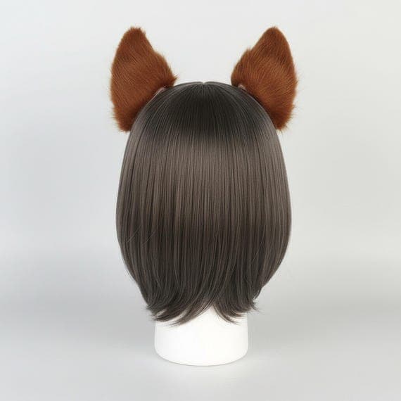Fox ear hair clips on mannequin head with dark brown wig back view showing both ears from behind. Brown faux fur fox ears clipped into hair showing natural placement and solid brown outer fur. Clip on fox ear cosplay accessory rear view kitsune ears hair clips for anime con halloween festival therian