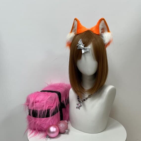 Show off your love for cats with this soft faux fur set of cat ears, paws, mask, and tail. The set is designed with a mix of brown and white fur to bring your cosplay to life. Petplay, furry fans, and fursuiters will appreciate the realistic details, including the wiggly tail and cute paw gloves with tiny claws. Perfect for cosplay events, roleplay, and Halloween parties. Customize it for a personal touch.