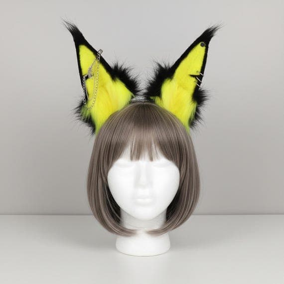 Yellow and black punk wolf ear headband with silver chain and metal spike piercings on mannequin head. Plush faux fur wolf dog ears with bright yellow inner fur and black outer fur. Gothic punk cosplay headband for halloween anime con festival rave.
