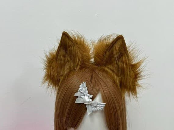 Close-up of brown faux fur fox or wolf ears headband showing realistic texture for cosplay costume