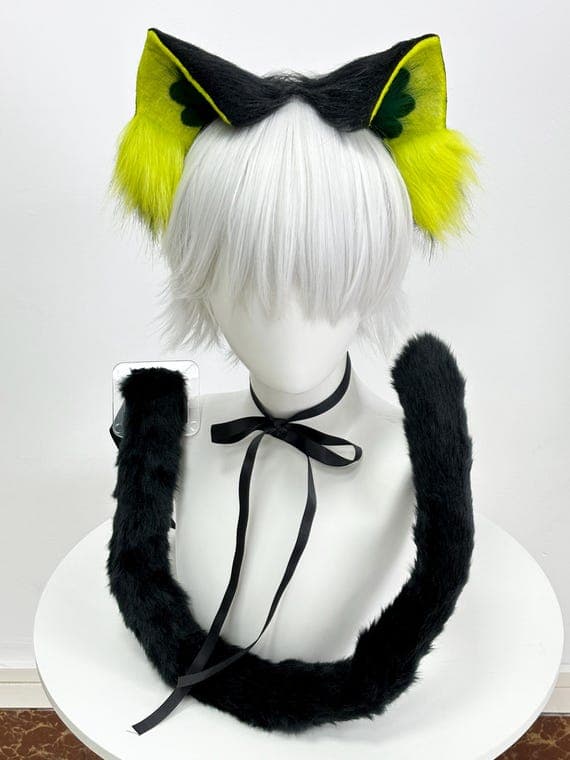 Neon yellow lime cat ears headband with matching black tail set displayed on white mannequin, showing bright fluorescent yellow-green faux fur perfect for rave festival EDM cosplay anime convention Halloween costume therian kemonomimi furry meetup. Electric yellow outer ears with dark olive green inner accents and fluffy yellow tufts create vibrant eye-catching look. Complete set includes cat ear headband plus long black tail with adjustable attachment for neko catgirl costume builds.