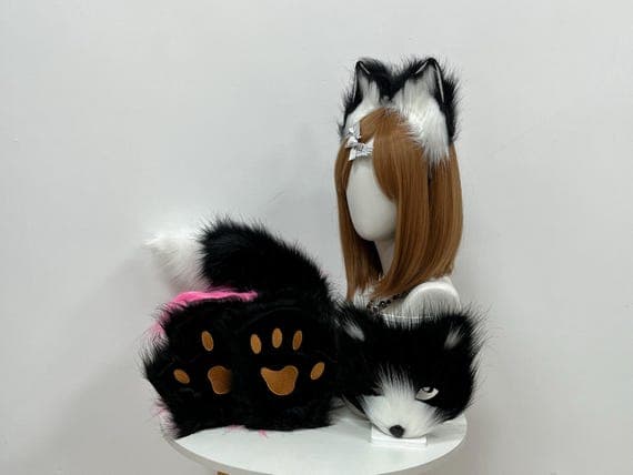 Realistic black and white faux fur cat tail for cosplay and Halloween costume play. Soft and fluffy, the tail is designed for comfortable wear, with a realistic look and adjustable features for easy attachment. Ideal for animal role-play, pet play, and cosplay fans. Perfect for those looking to complete their catgirl look, the tail provides an adorable addition to any furry or feline-inspired costume. Custom-made for the perfect fit and a must-have accessory for every furry enthusiast.