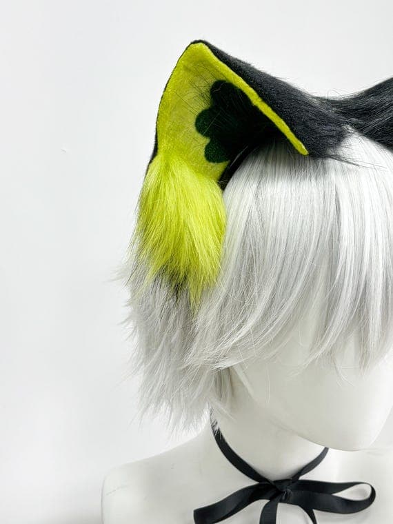 Extreme close-up macro detail shot of neon yellow electric lime cat ear showing high-quality faux fur texture with bright fluorescent yellow outer fur, dark olive-green inner ear accents, and fluffy lime yellow tufts at base. Premium synthetic fur construction is soft realistic cruelty-free, perfect for professional cosplay builds. Close detail reveals vibrant color variation from neon yellow to lime green creating dimensional realistic cat ear appearance for rave festival anime con Halloween co