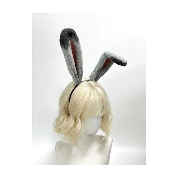 Side angle view grey bunny rabbit ears headband showing poseable wire frame construction allowing ears to bend hold shape for custom character cosplay builds. Realistic rabbit ear proportions with grey faux fur exterior dusty rose pink inner detail creates authentic bunny look perfect for Easter Halloween anime convention costume. Slim comfortable headband base stays secure through movement dancing ideal for rave festival cosplay photoshoots. Premium plush faux fur soft realistic cruelty-free fo