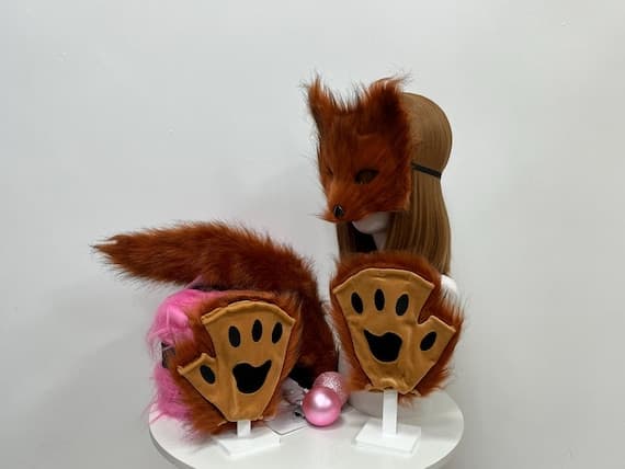 Plush fox ears, paws, and tail set, perfect for fox-themed cosplay and costume accessories. Made with soft faux fur, the ears and paws offer a cute, fluffy look that’s both stylish and comfortable. The tail, also made from faux fur, is designed to be lightweight and easy to wear with a convenient clip attachment. This set is ideal for Halloween costumes, cosplay events, furry fandom gatherings, or photoshoots with animal-inspired outfits