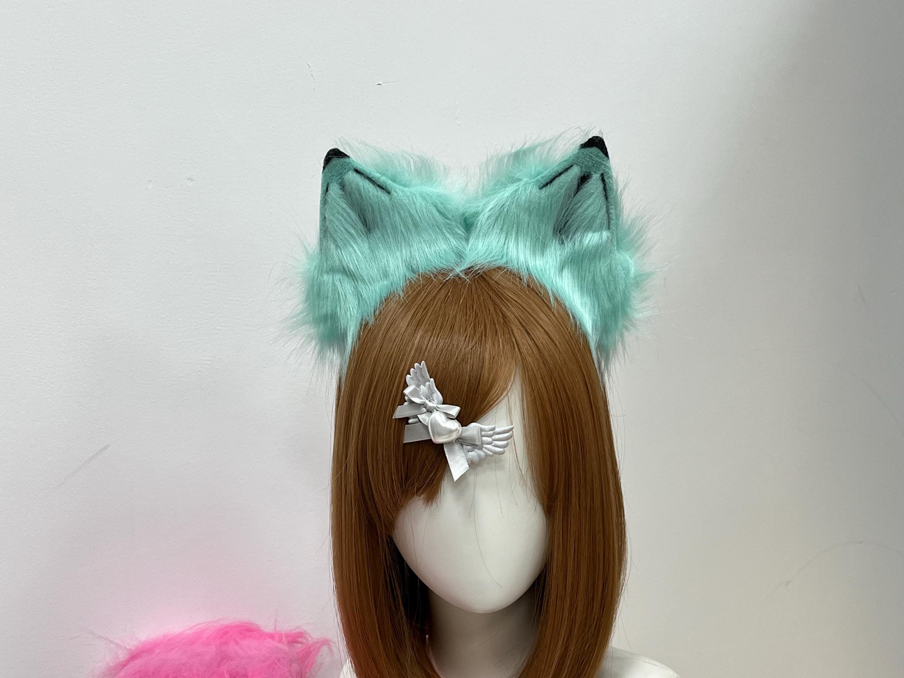 Close up front view of handmade turquoise and mint faux fur wolf ears on a comfy headband, showing tall pointed ear shape with aqua pastel inner fluff and tiny jet black tips. Perfect kemonomimi accessory for mermaid themed cosplay, pastel goth looks, anime con outfits, Halloween sea witch costumes, and therian fursona builds. Light sea green color pops against any hair shade and makes a striking statement for catgirl and wolf hybrid characters at furry meetups everywhere.