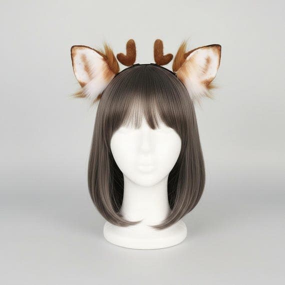 Brown deer ear headband with antlers featuring pointed faux fur ears with white felt inner panels wispy golden-brown fur tufts at bases and two plush heart-shaped antler nubs on slim metal headband on mannequin head with bob wig, deer ears fawn ears antler headband deer antler headband cosplay ears faux fur ears animal ears headband cosplay animal ears deer ear headband deer headband furry deer ears cosplay antlers costume ears animal cosplay against grey studio background